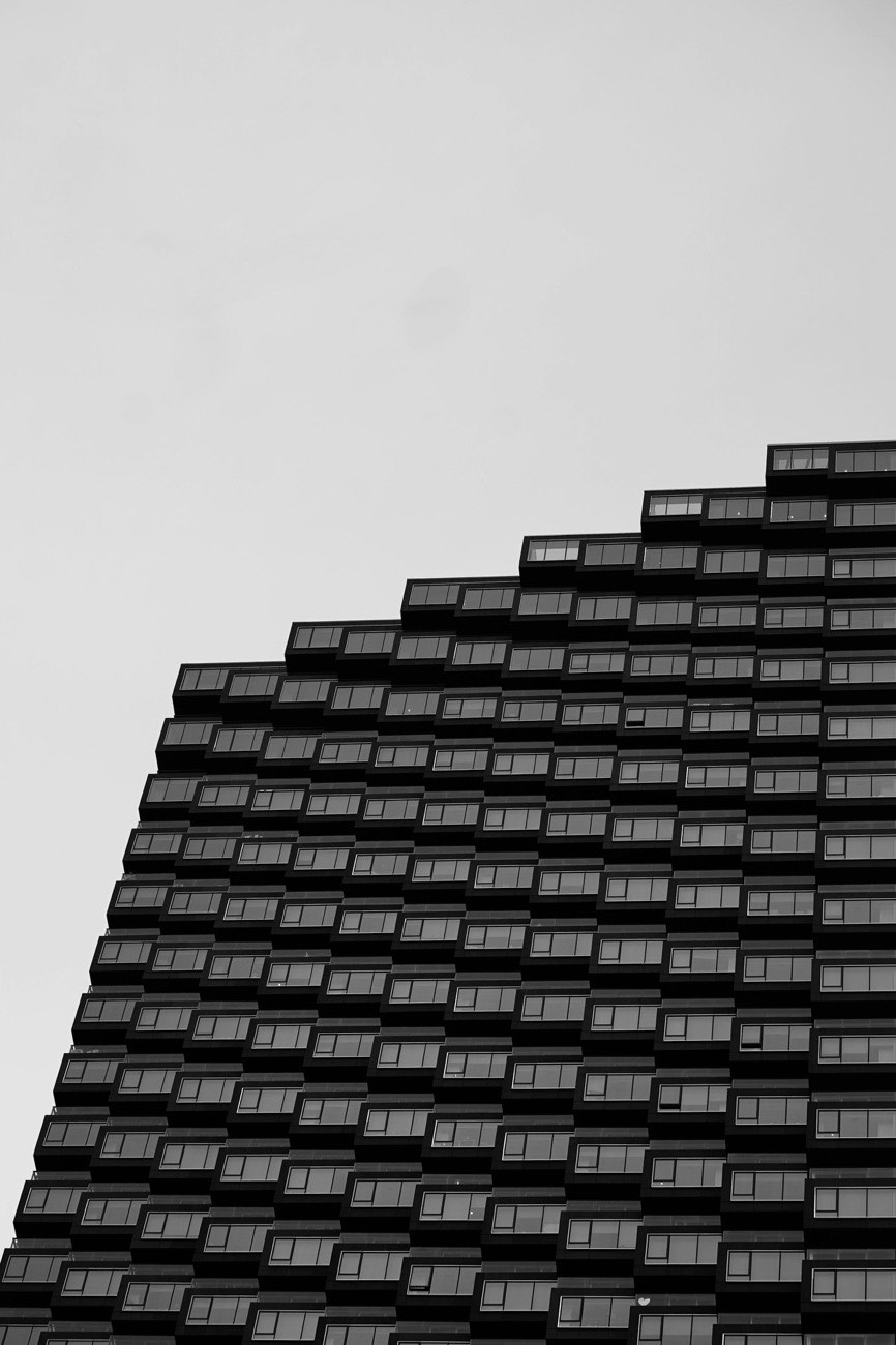 A stepped apartment building facade, each floor offset from the one below
